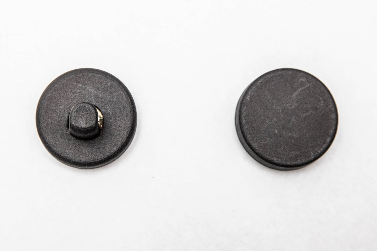 Front and back magnets of the wreath hanger shown apart, one for each side of the glass